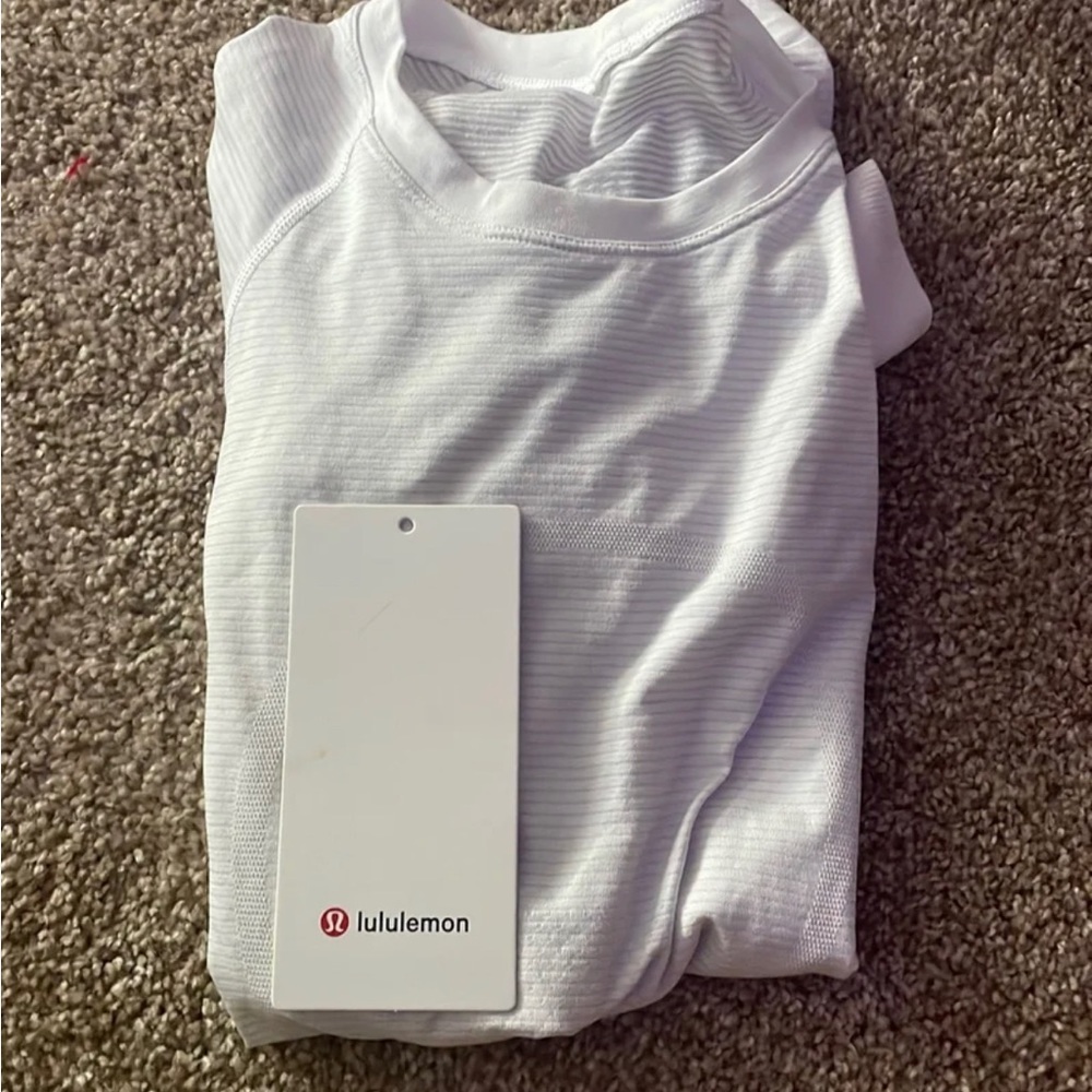 a white swiftly tech, worn twice, basically new! comes with tag unattached.